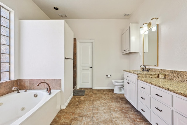 bathroom with vanity, toilet, and a bathtub