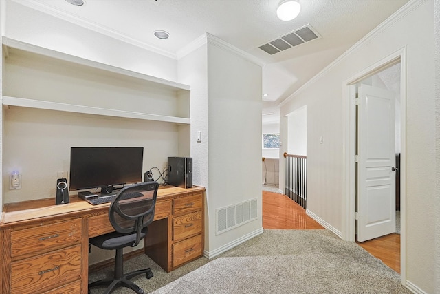 carpeted office space featuring a textured ceiling and crown molding