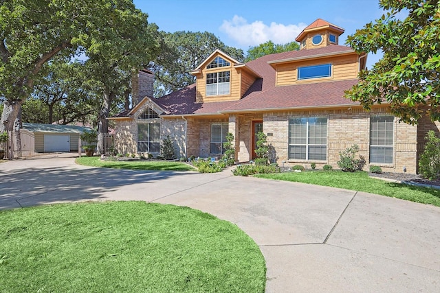 view of front facade with an outbuilding and a garage