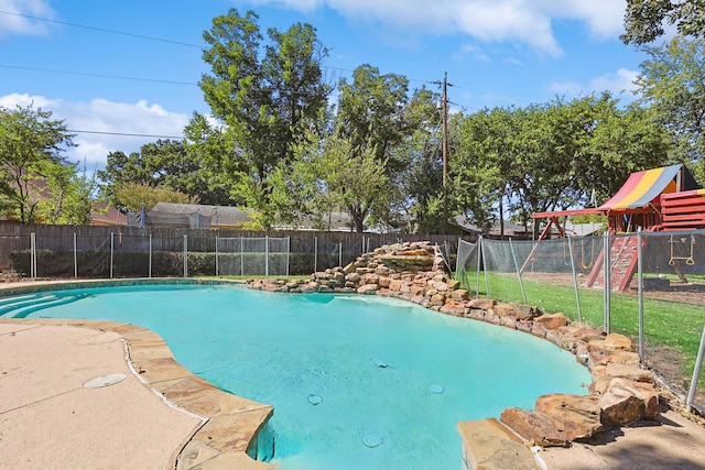 view of swimming pool with a playground