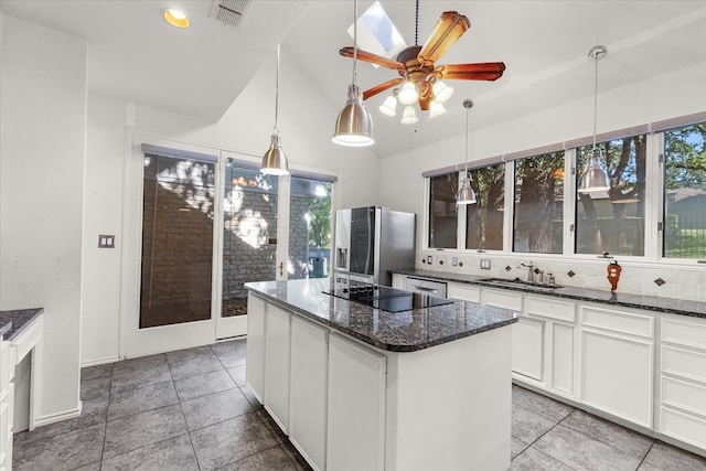 unfurnished dining area with a chandelier, dark tile patterned floors, and vaulted ceiling