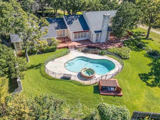 view of swimming pool with a yard, a patio area, and an in ground hot tub