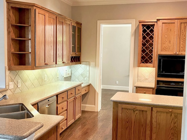 kitchen featuring decorative backsplash, black appliances, dark wood-type flooring, crown molding, and sink