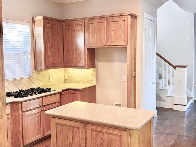 kitchen featuring tasteful backsplash, black gas cooktop, and dark hardwood / wood-style floors