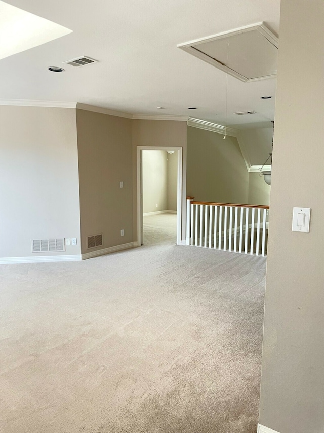 empty room featuring ornamental molding and carpet