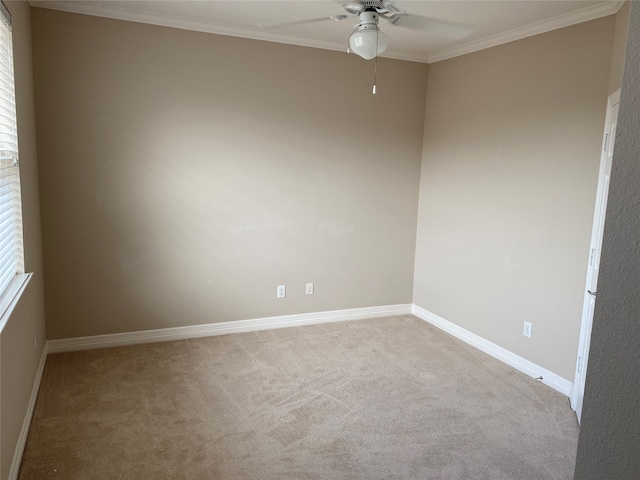 carpeted spare room featuring ornamental molding and ceiling fan