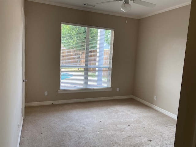 carpeted empty room with crown molding and ceiling fan