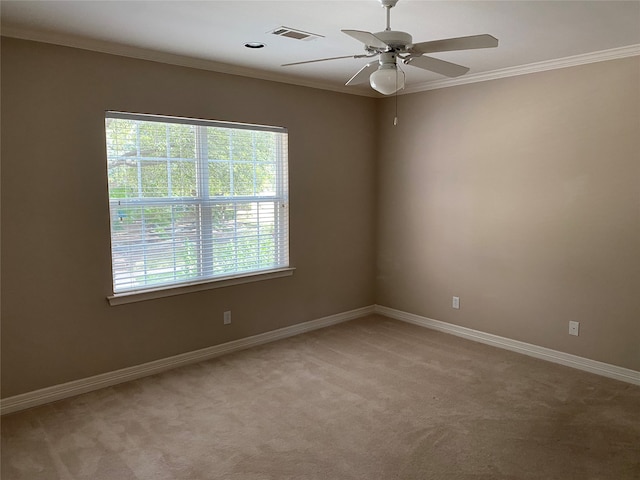 carpeted empty room with ornamental molding and ceiling fan