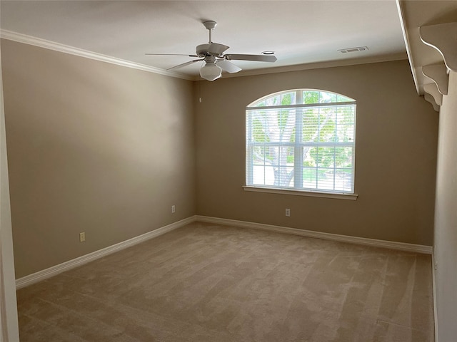 carpeted empty room featuring ornamental molding and ceiling fan