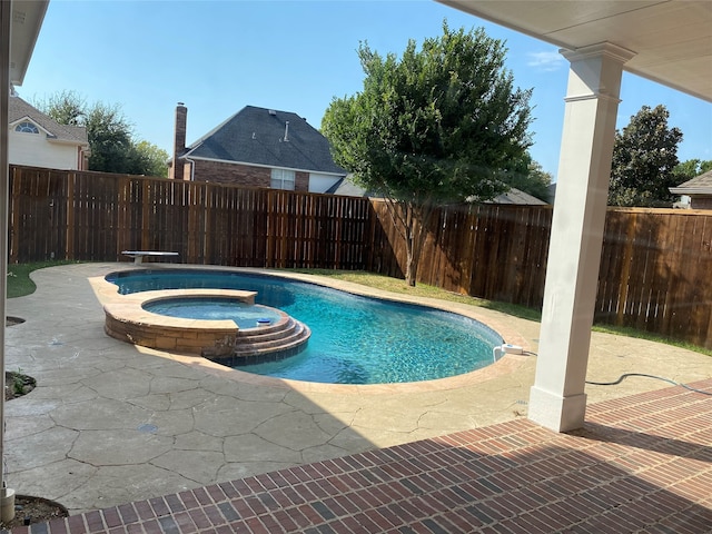 view of swimming pool with a patio area, an in ground hot tub, and a diving board