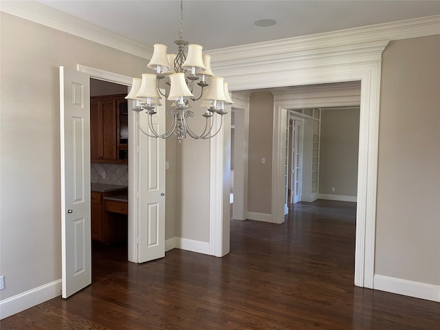 unfurnished dining area with a chandelier, crown molding, and dark hardwood / wood-style flooring