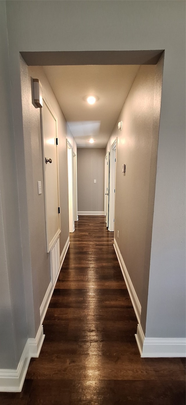 corridor with dark hardwood / wood-style floors