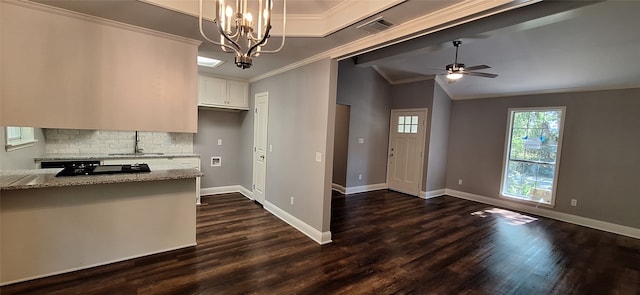 kitchen featuring white cabinets, light stone countertops, dark hardwood / wood-style floors, pendant lighting, and sink