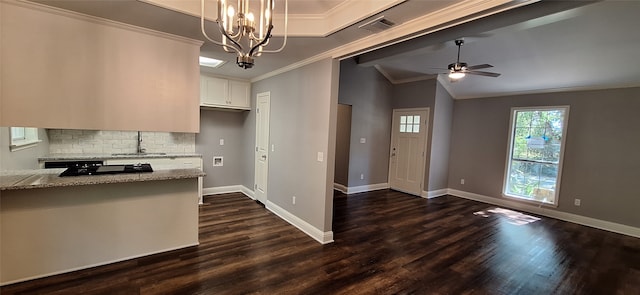 kitchen featuring dark wood-type flooring, sink, light stone countertops, decorative light fixtures, and white cabinets