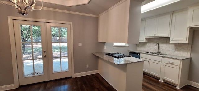 kitchen with white cabinets, sink, light stone counters, and dark hardwood / wood-style floors