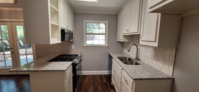 kitchen featuring appliances with stainless steel finishes, white cabinets, sink, and light stone counters