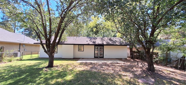 rear view of property with a lawn