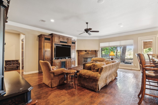 living room with dark wood-type flooring, ceiling fan, and ornamental molding