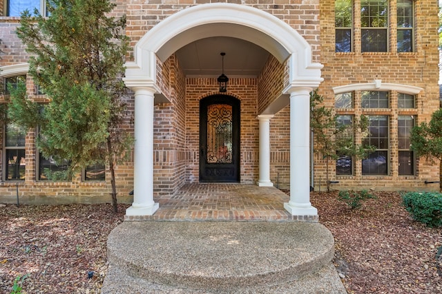 view of exterior entry featuring covered porch