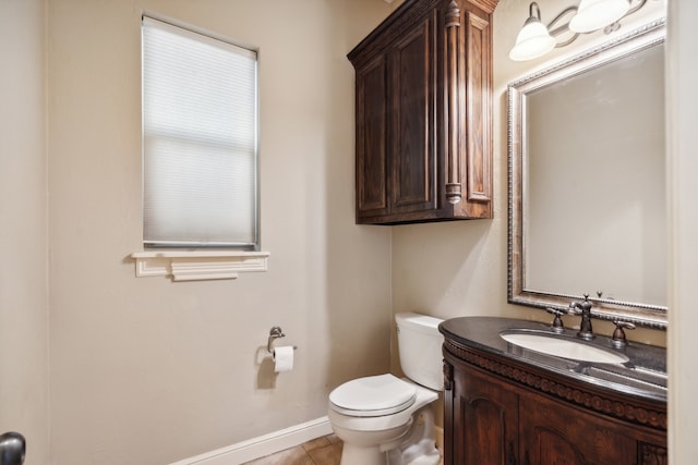 bathroom featuring toilet, vanity, and tile patterned floors