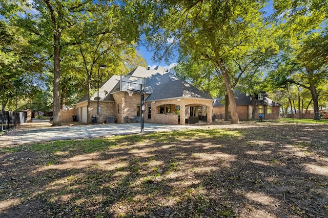 back of house featuring central AC