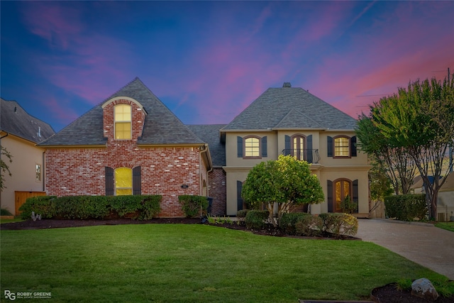 french country style house featuring a lawn