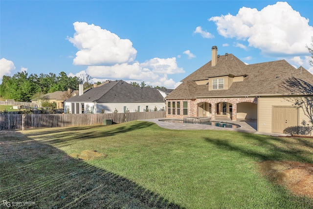 rear view of property featuring a patio area and a lawn