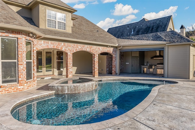 view of pool with a patio and an in ground hot tub