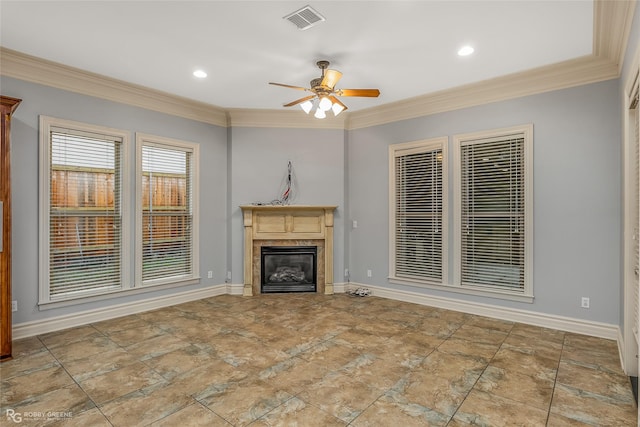 unfurnished living room with crown molding, ceiling fan, and a fireplace