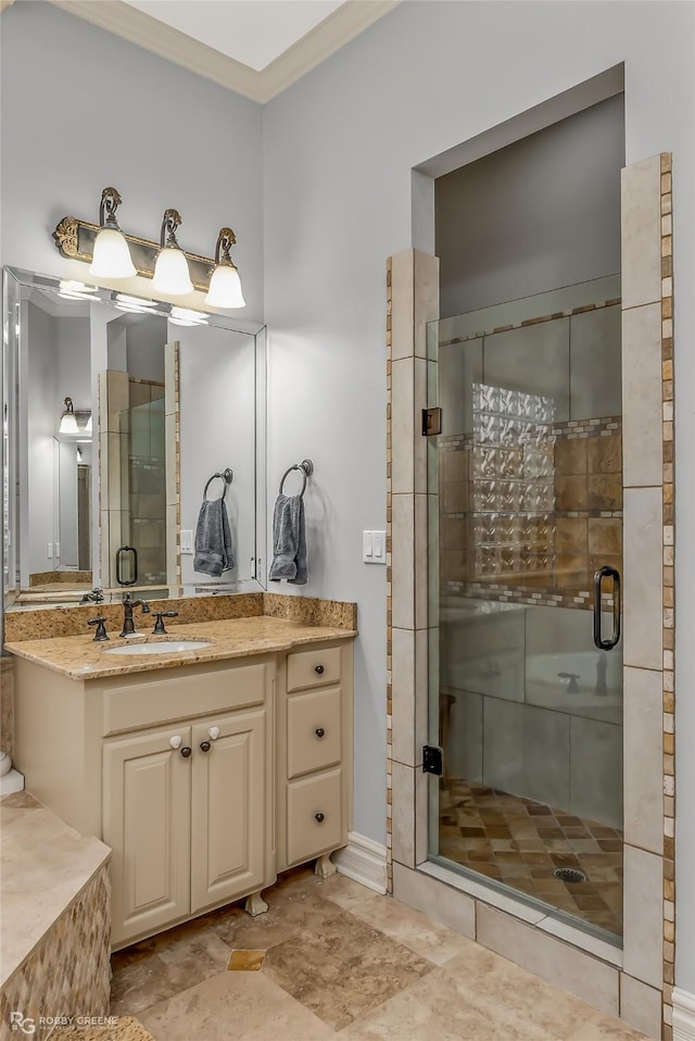 bathroom featuring a shower with door and vanity