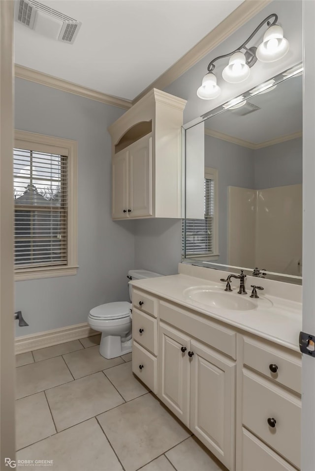 bathroom with crown molding, vanity, tile patterned floors, toilet, and walk in shower