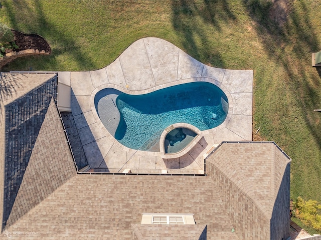 view of swimming pool featuring an in ground hot tub and a lawn