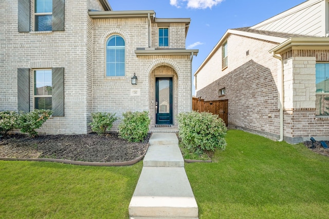 doorway to property with a lawn