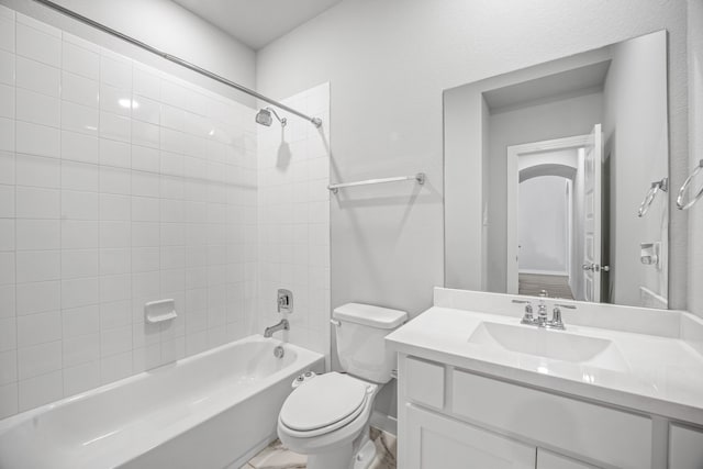 full bathroom featuring toilet, vanity, and tiled shower / bath