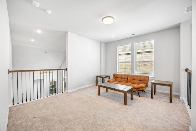 sitting room featuring light carpet