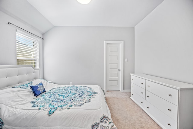 carpeted bedroom with vaulted ceiling