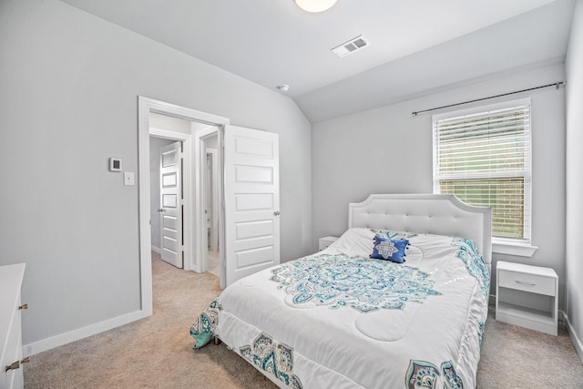 bedroom featuring light carpet and lofted ceiling