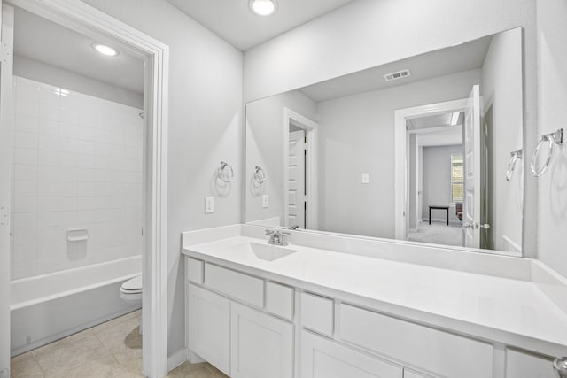 bathroom featuring tile patterned flooring, vanity, and tiled shower / bath combo