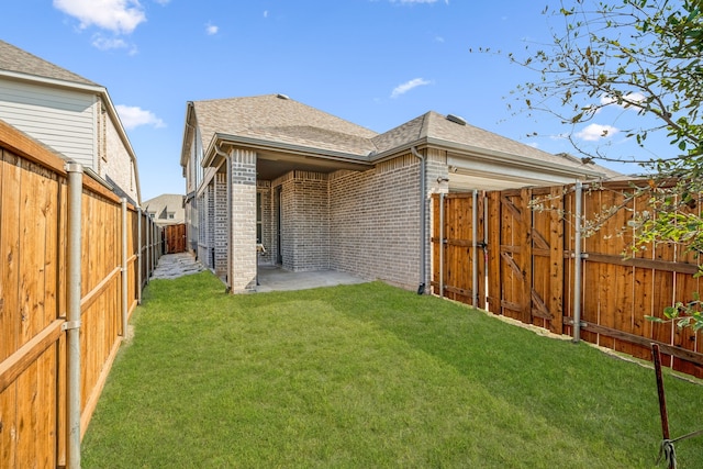 rear view of property with a lawn and a patio area