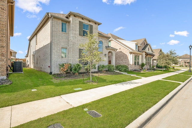 view of front of property with cooling unit and a front yard