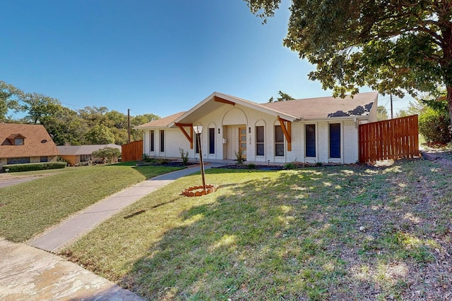 ranch-style home with a front yard