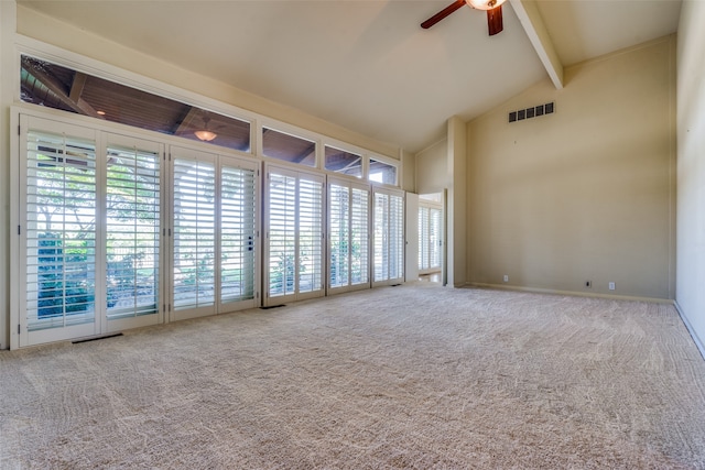 unfurnished room with beam ceiling, carpet floors, a healthy amount of sunlight, and ceiling fan