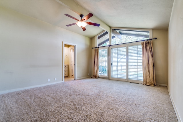 unfurnished room with lofted ceiling with beams, light carpet, and a healthy amount of sunlight