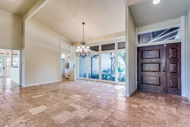 entrance foyer with a notable chandelier, high vaulted ceiling, and plenty of natural light