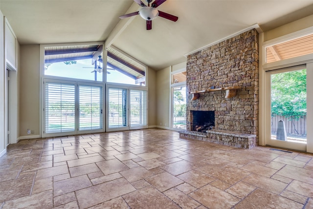 unfurnished living room featuring ceiling fan, a stone fireplace, and a wealth of natural light