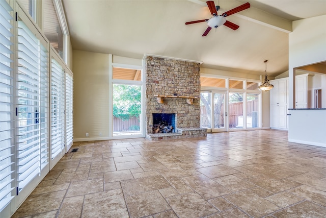 unfurnished living room featuring ceiling fan, high vaulted ceiling, a fireplace, and a wealth of natural light