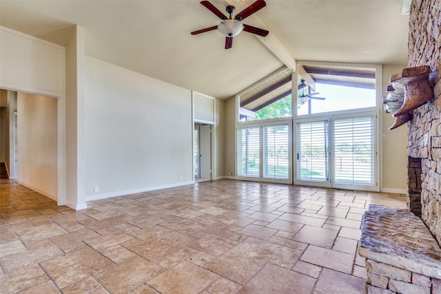 unfurnished living room featuring a stone fireplace, beam ceiling, high vaulted ceiling, and ceiling fan