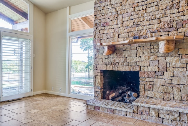 unfurnished living room with wooden ceiling, a fireplace, and vaulted ceiling