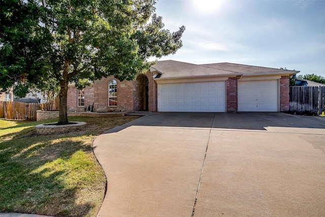 view of front of home featuring a front lawn and a garage