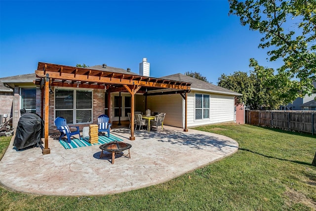 rear view of property with a patio, a fire pit, a yard, and a pergola